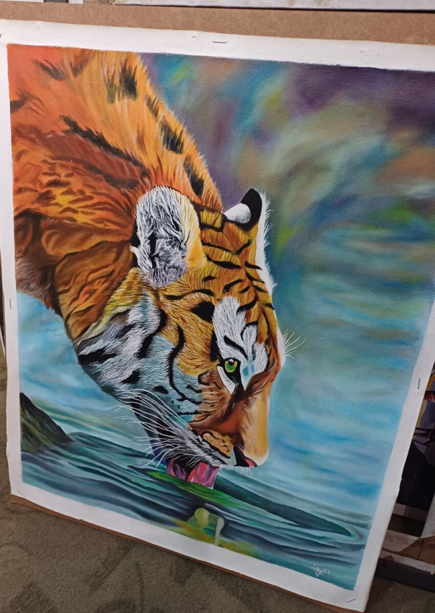 Tiger drinking water on artwork